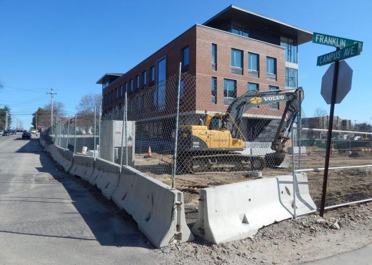 Secure construction site with excavator