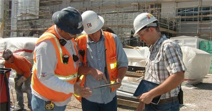 Construction workers following organization safety training protocol