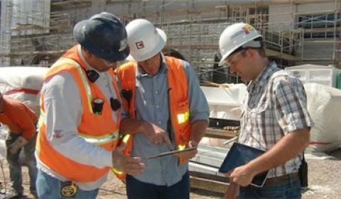 Construction workers following organization safety training protocol